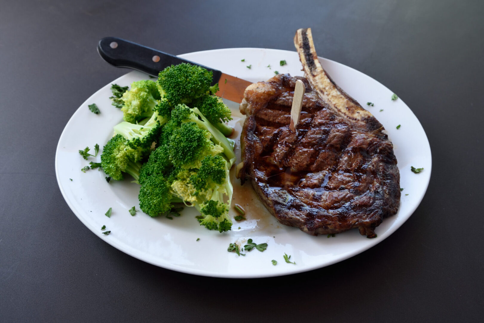 Leff T's Steakhouse bone-in ribeye with a side of broccoli