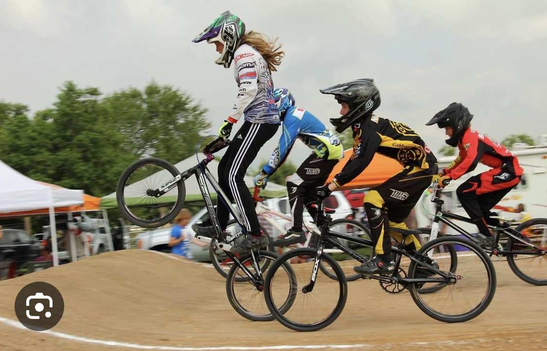 BMX bike riders racing on dirt track