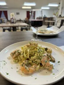 pasta with shrimp and glass of wine