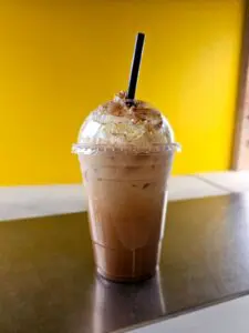 close up of cold coffee drink with whipped cream